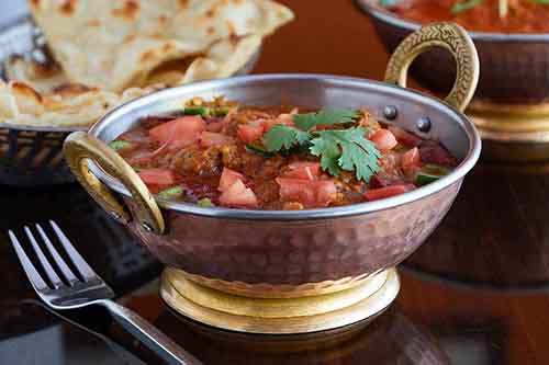 Indian Food East Hanover Morris County 7. Lamb Roganjosh

Translating roughly into “red lamb,” this dish gets its flavor from cardamom, cumin and cloves. Roganjosh is of of Persian or Kashmiri origin. It is one of the signature recipes of Kashmiri cuisine
