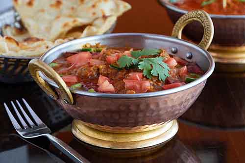 Indian Food East Hanover Morris County 7. Lamb Roganjosh

Translating roughly into “red lamb,” this dish gets its flavor from cardamom, cumin and cloves. Roganjosh is of of Persian or Kashmiri origin. It is one of the signature recipes of Kashmiri cuisine